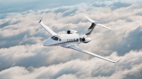 Embraer Phenom 300 Flying Over Clouds