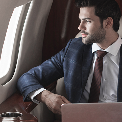 Professional in tie gazing out cabin window