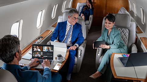 People on devices sitting in cabin