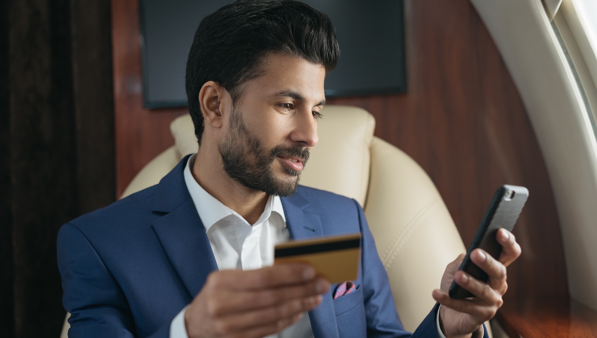 Man holding a phone and credit card