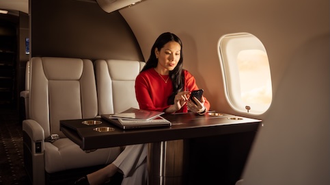 Teaser - Woman in red shirt looking at phone in cabin Teaser - Woman in red shirt looking at phone in cabin