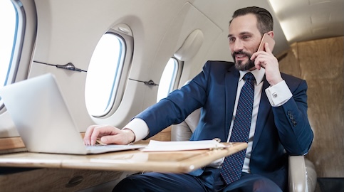 Man on a phone and laptop in cabin