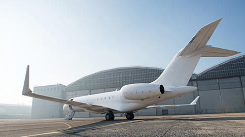 White Bombardier Global 6000 in front of hangar